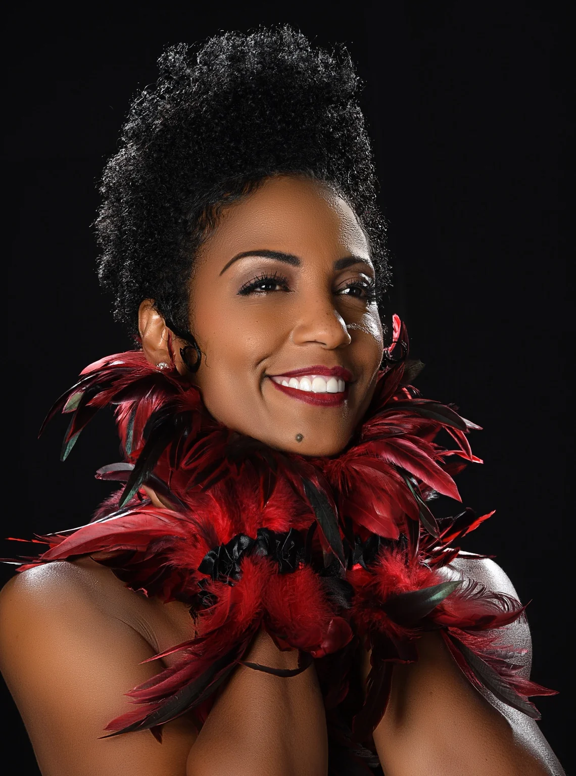Yvette Spears wearing red and black feathers