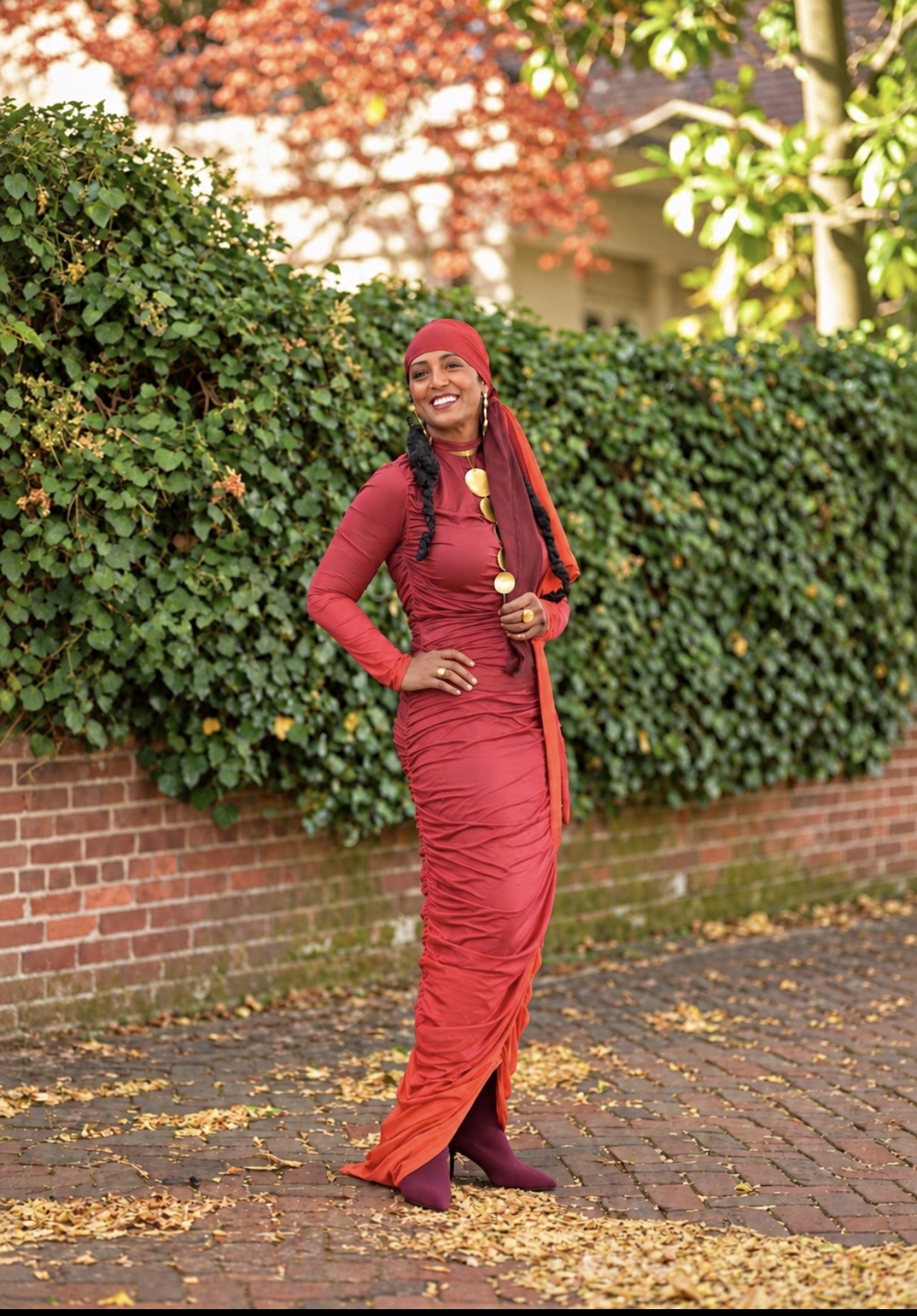Yvette Spears in a red ensemble and headscarf, photographed outdoors